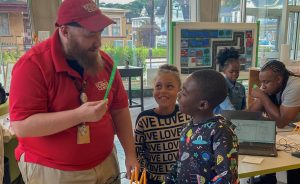 Man showing kids pencil