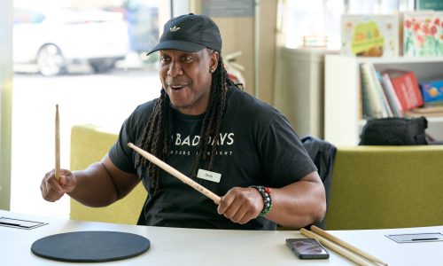 man teaching drumming